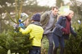 Outdoor Family Choosing Christmas Tree Together Royalty Free Stock Photo