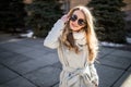 Outdoor fashion closeup portrait of young pretty woman in sunglases walking on street Royalty Free Stock Photo