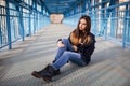 Outdoor fashion lifestyle portrait of pretty young girl, wearing in hipster swag grunge style urban background. Tomboy city Royalty Free Stock Photo