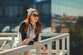 Outdoor fashion lifestyle portrait of pretty young girl, wearing in hipster swag grunge style urban background. Tomboy city Royalty Free Stock Photo