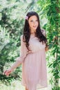 Outdoor fashion photo of beautiful young happy smiling woman surrounded by flowers. Spring blossom Royalty Free Stock Photo