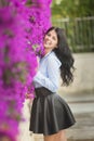 Outdoor fashion photo of beautiful young woman surrounded by flowers Royalty Free Stock Photo