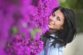 Outdoor fashion photo of beautiful young woman surrounded by flowers Royalty Free Stock Photo