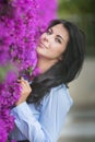Outdoor fashion photo of beautiful young woman surrounded by flowers Royalty Free Stock Photo