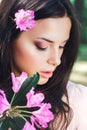 Outdoor fashion photo of beautiful young woman surrounded by flowers. Spring blossom Royalty Free Stock Photo