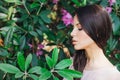 Outdoor fashion photo of beautiful young woman surrounded by flowers. Spring blossom Royalty Free Stock Photo