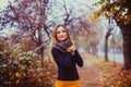 Outdoor fashion photo of young beautiful lady in autumn cold day.