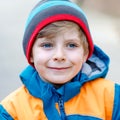 Outdoor fashion portrait of adorable little kid boy wearing colorful clothes. Spring, summer or autumn fashion for boys Royalty Free Stock Photo