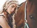 Beautiful young girl with brown horse Royalty Free Stock Photo