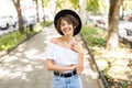 Portrait of glamour sensual young stylish lady wearing trendy fall outfit , black hat in the summer street Royalty Free Stock Photo