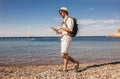 Handsome stylish tourist guy posing at the beach