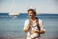 Portrait of handsome stylish tourist man posing at the beach