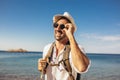 Portrait of handsome stylish tourist man posing at the beach