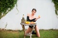 Outdoor fashion portrait of pretty girl in sexy pose relaxing near summer garden with tropical fruits. Romantic young Royalty Free Stock Photo