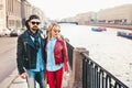 Outdoor fashion portrait of stylish couple walking on sunset at the city street wearing biker leather total black rock n roll look Royalty Free Stock Photo