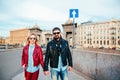 Outdoor fashion portrait of stylish couple walking on sunset at the city street wearing biker leather total black rock n roll look Royalty Free Stock Photo