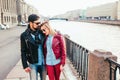 Outdoor fashion portrait of stylish couple walking on sunset at the city street wearing biker leather total black rock n roll look Royalty Free Stock Photo