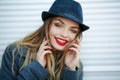 Outdoor fashion portrait of young beautiful fashionable woman wearing stylish accessories.vintage hat,looking at camera Royalty Free Stock Photo