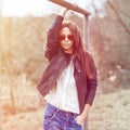 Outdoor fashion toned colors portrait of young woman in jea Royalty Free Stock Photo
