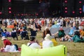 Outdoor festival atmosphere with enthusiastic crowd and dynamic stage lights Royalty Free Stock Photo