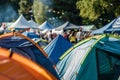 outdoor festival tents with crowds mingling in the background