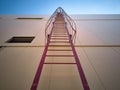 Outdoor fire escape ladder on industrial building wall Royalty Free Stock Photo