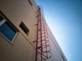 Outdoor fire escape ladder on industrial building wall Royalty Free Stock Photo