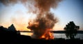 Outdoor fire nearby a lake in the summer in Denmark Royalty Free Stock Photo