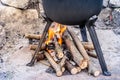 Outdoor fireplace under a cast-iron pot with roasts. barbeque party