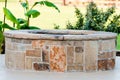 Outdoor flagstone firepit with landscape in background.
