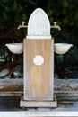 Outdoor fresh tap water faucet and stone pool on the street Royalty Free Stock Photo