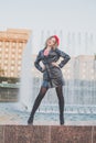 Outdoor full-length portrait of young elegant woman fashion model wearing red trench cap and black jacket  posing. Autumn fashion Royalty Free Stock Photo