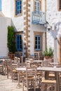 Outdoor furniture of street cafe in old greek town. Royalty Free Stock Photo