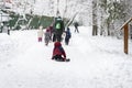 Outdoor games, winter leisure, several of unrecognizable little kids with teachers of kindergarten, walk holding hands Royalty Free Stock Photo