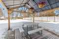 Outdoor gazebo with built-in benches and a vibrant array of flowers decorating the structure