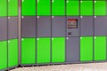 Outdoor green automated public lockers with touchscreen display. Autonomous post parcel terminal.Self-service street cloackroom ce