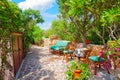 Outdoor green garden beach patio wooden bench in backyard porch of home with nobody in Sardinia Royalty Free Stock Photo