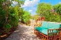 Outdoor green garden beach patio wooden bench in backyard porch of home with nobody in Sardinia Royalty Free Stock Photo