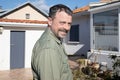 Outdoor handsome portrait of happy middle aged white happy man in home garden Royalty Free Stock Photo