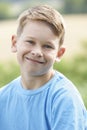 Outdoor Head And Shoulder Portrait Of Smiling Boy
