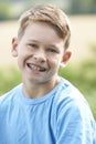 Outdoor Head And Shoulder Portrait Of Smiling Boy