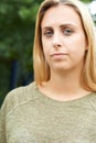 Outdoor Head And Shoulders Portrait Of Serious Teenage Girl