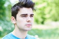 Outdoor Head And Shoulders Portrait Of Serious Young Man