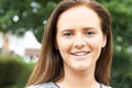 Outdoor Head And Shoulders Portrait Of Smiling Teenage Girl