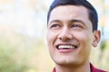 Outdoor Head And Shoulders Portrait Of Smiling Young Man