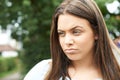 Outdoor Head And Shoulders Shot Of Serious Teenage Girl