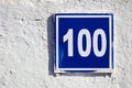 Outdoor house number one hundred 100 Royalty Free Stock Photo