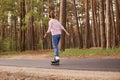 Outdoor image of energetic sleder young woman having training, being active, rollerblading alone, having rest, relaxing, enjoying