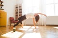 Woman stretching in room at home. Healthy and sport lifestyle. Fitness sport girl doing yoga fitness exercise. Royalty Free Stock Photo