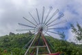 An outdoor iron pinwheel with seven colours rainbow for decoration in the park